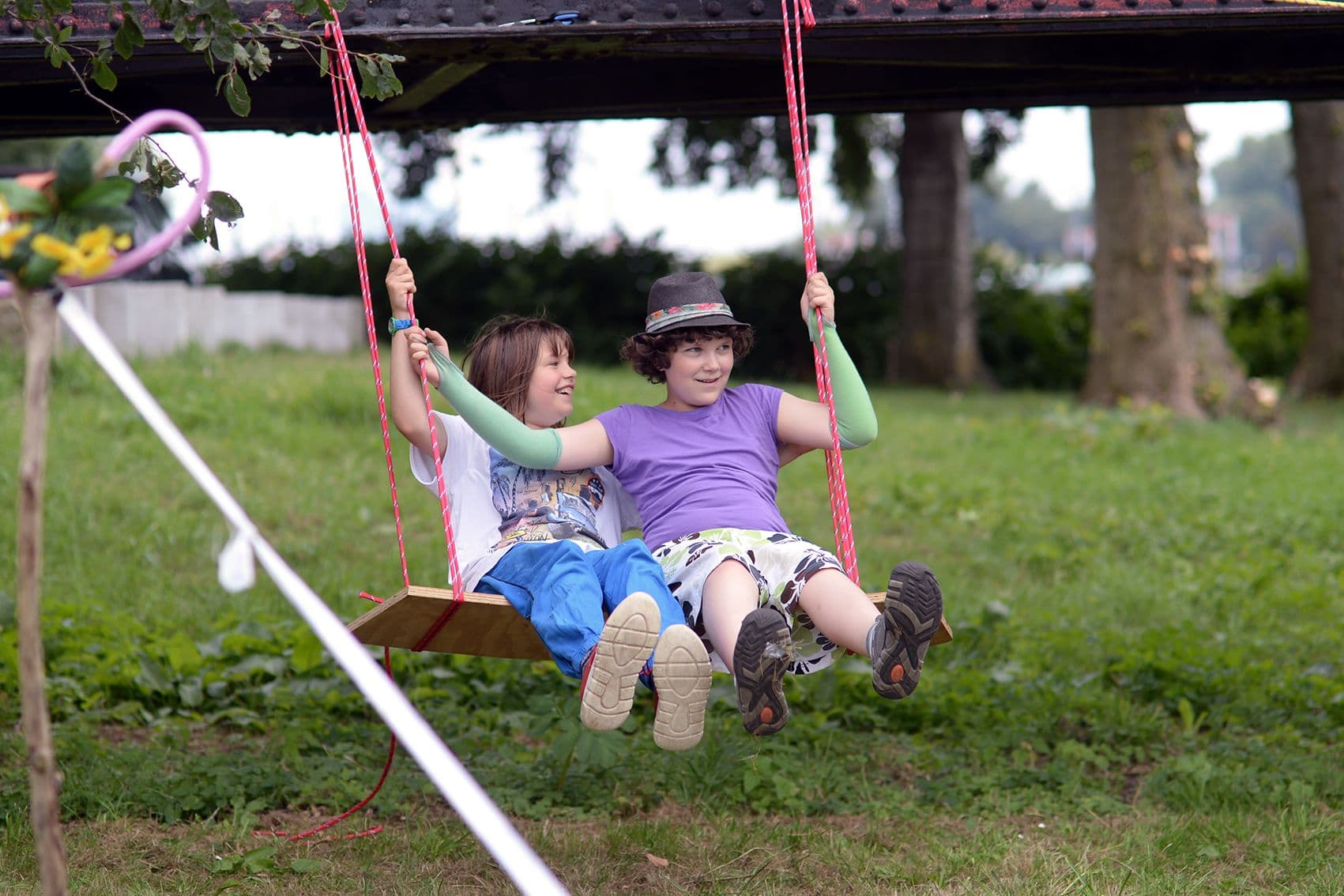 Youth enjoying time on a swing Supporting deprived youth in Germany gives them space to develop