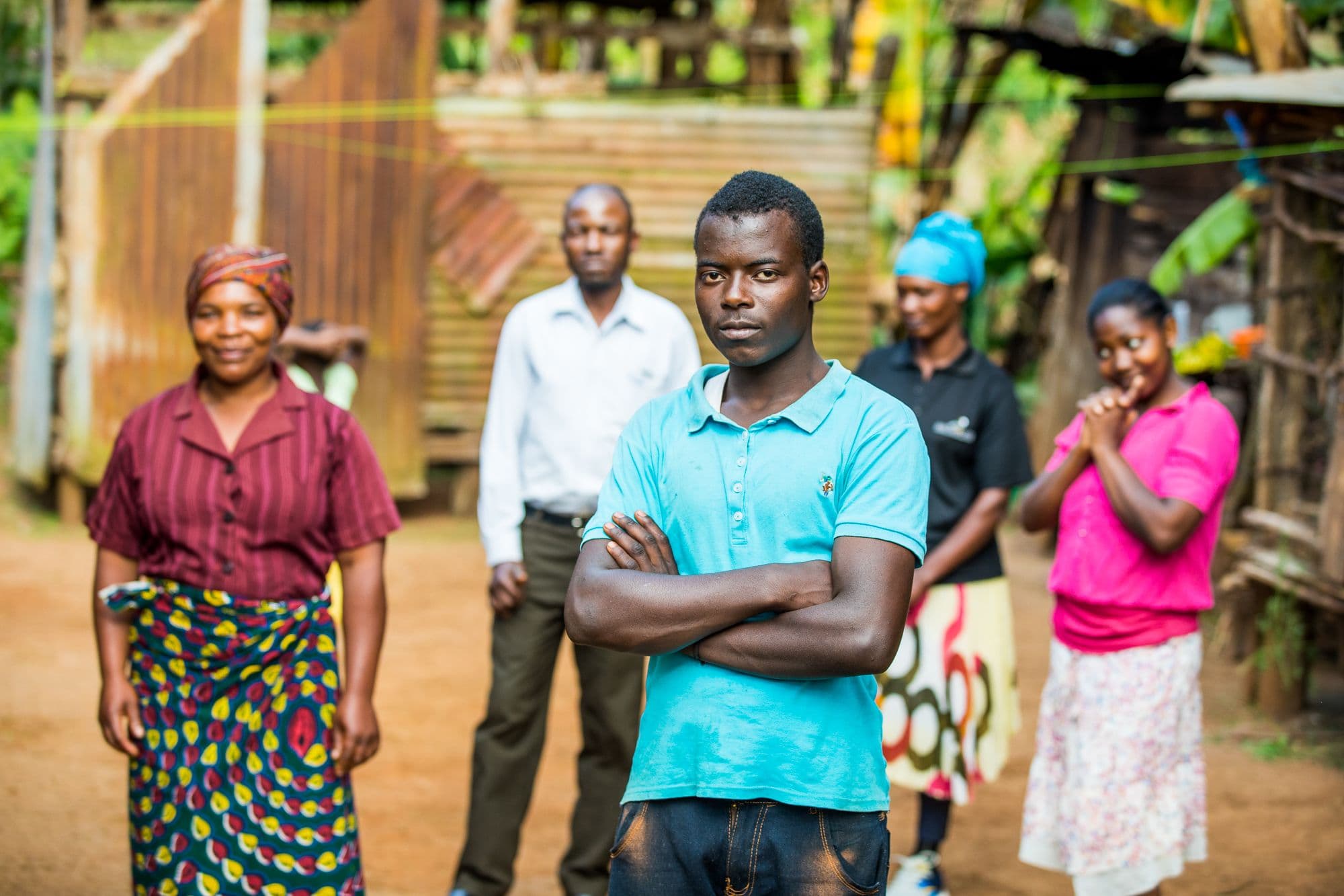 Youth needs to be put to the forefront of coffee farming families A young coffee farmer posing in front of his family