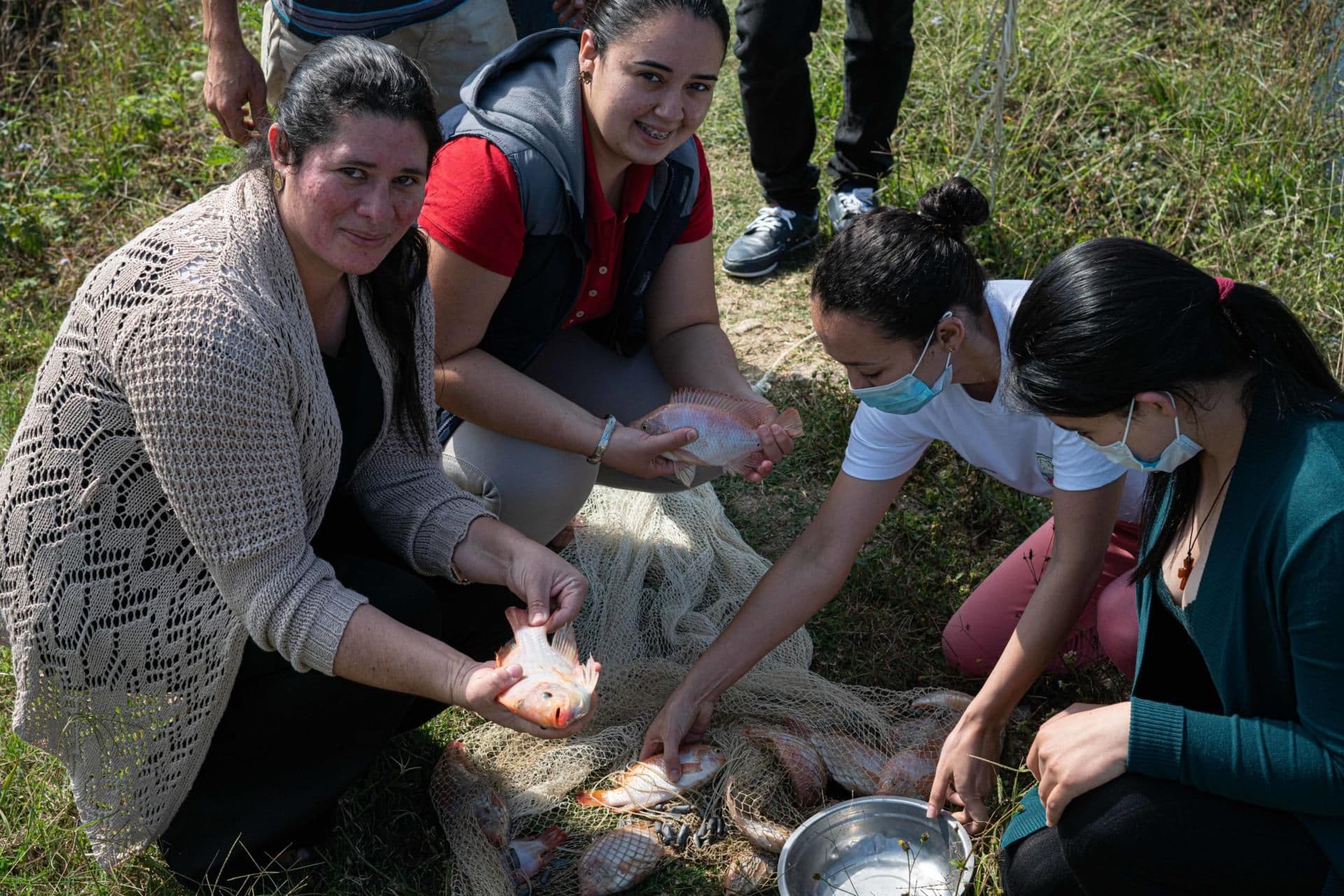 María teaching a group of women, part of the coffee cooperative, about fish farming